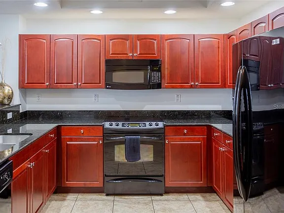 Modern kitchen interior with granite counters and GE Profile appliances